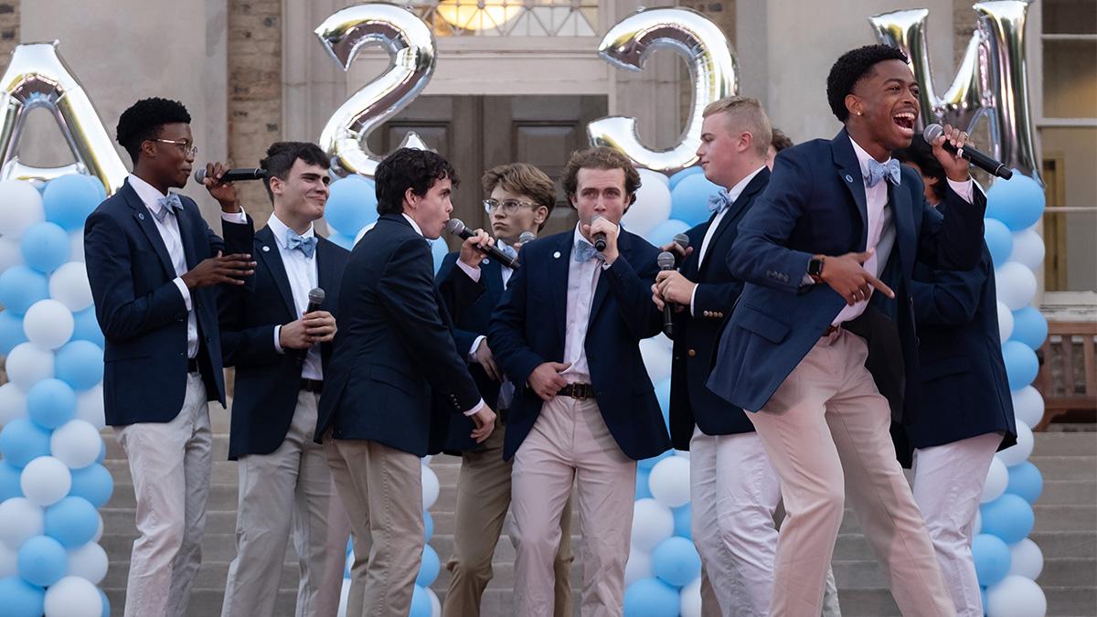 A cappella group performs in front of South Building